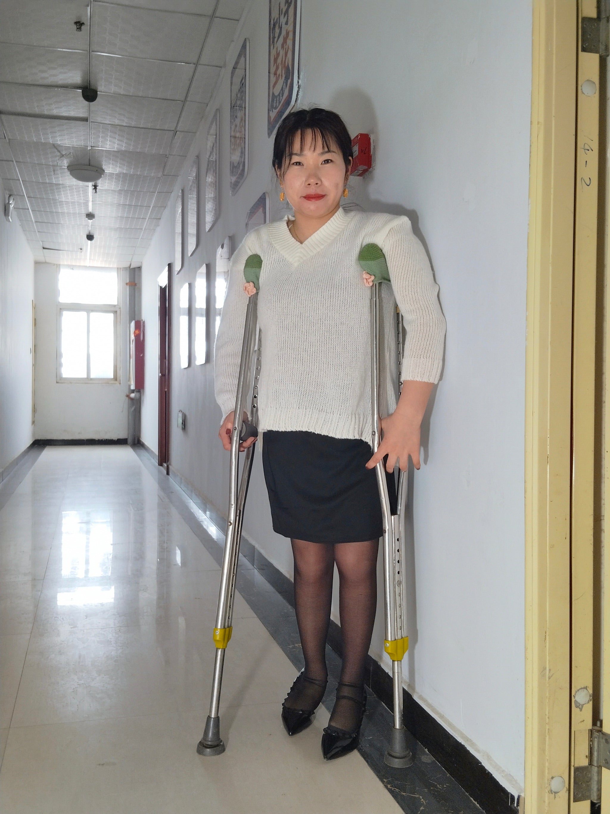 Twlia, a girl with polio - high heels and stockings going up and down stairs