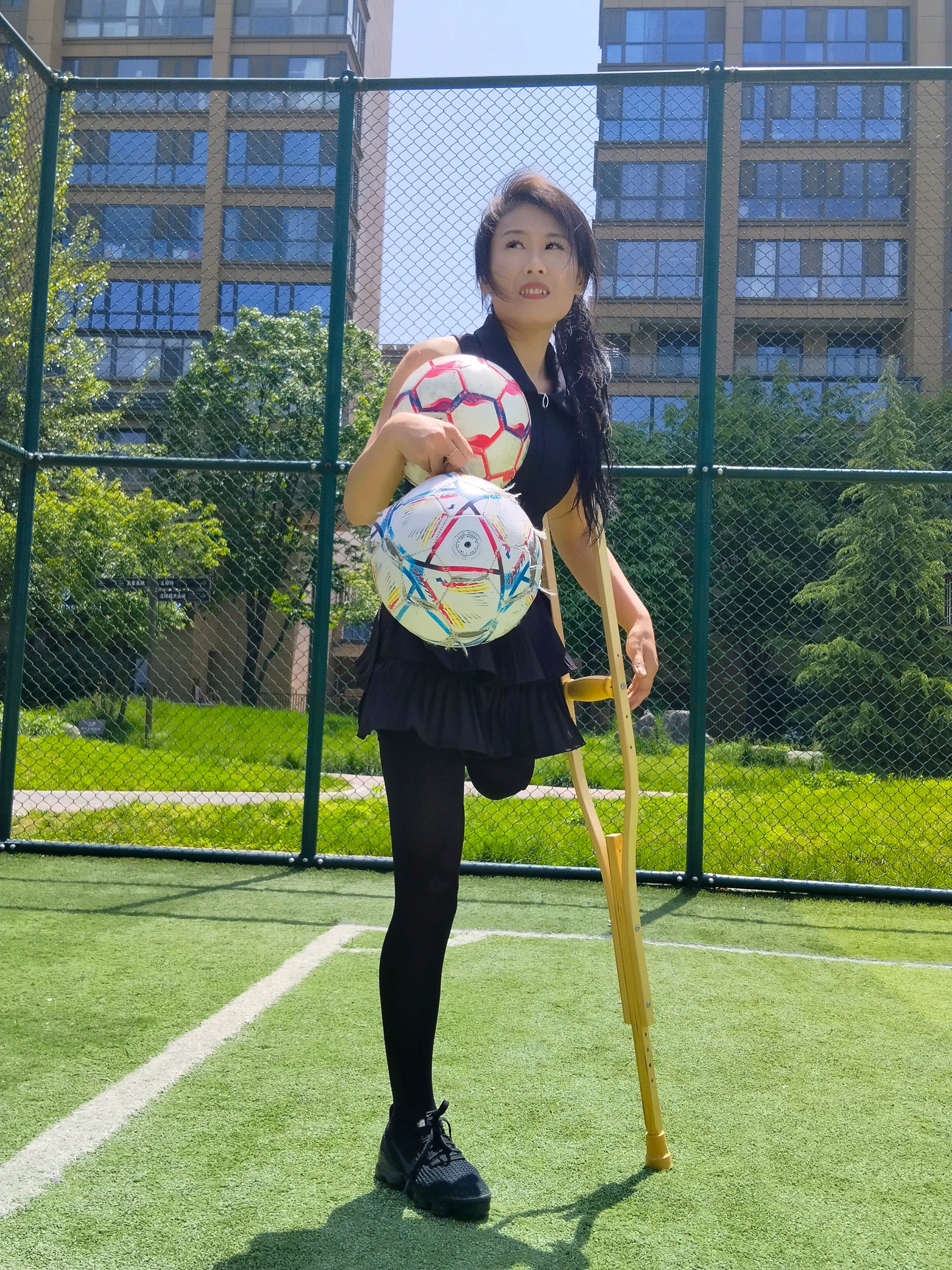 Ayla: Sak Amputee Girl – Happy times playing soccer with Lanzi while on crutches
