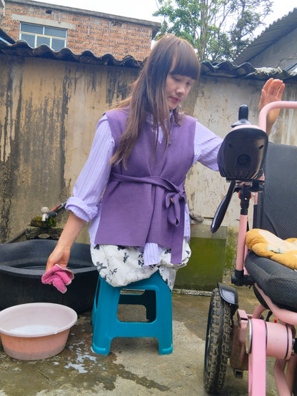The DAK Girl, Lvy — Sitting on a Bench, Cleaning a Wheelchair