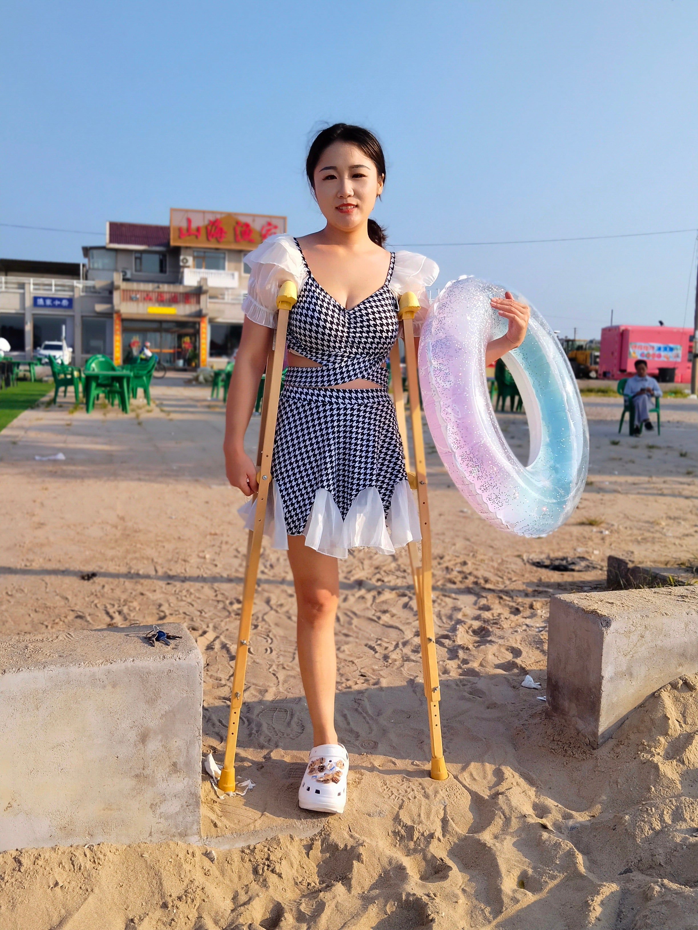 Naomi Sak, an amputee girl - swimming in the sea at the beach