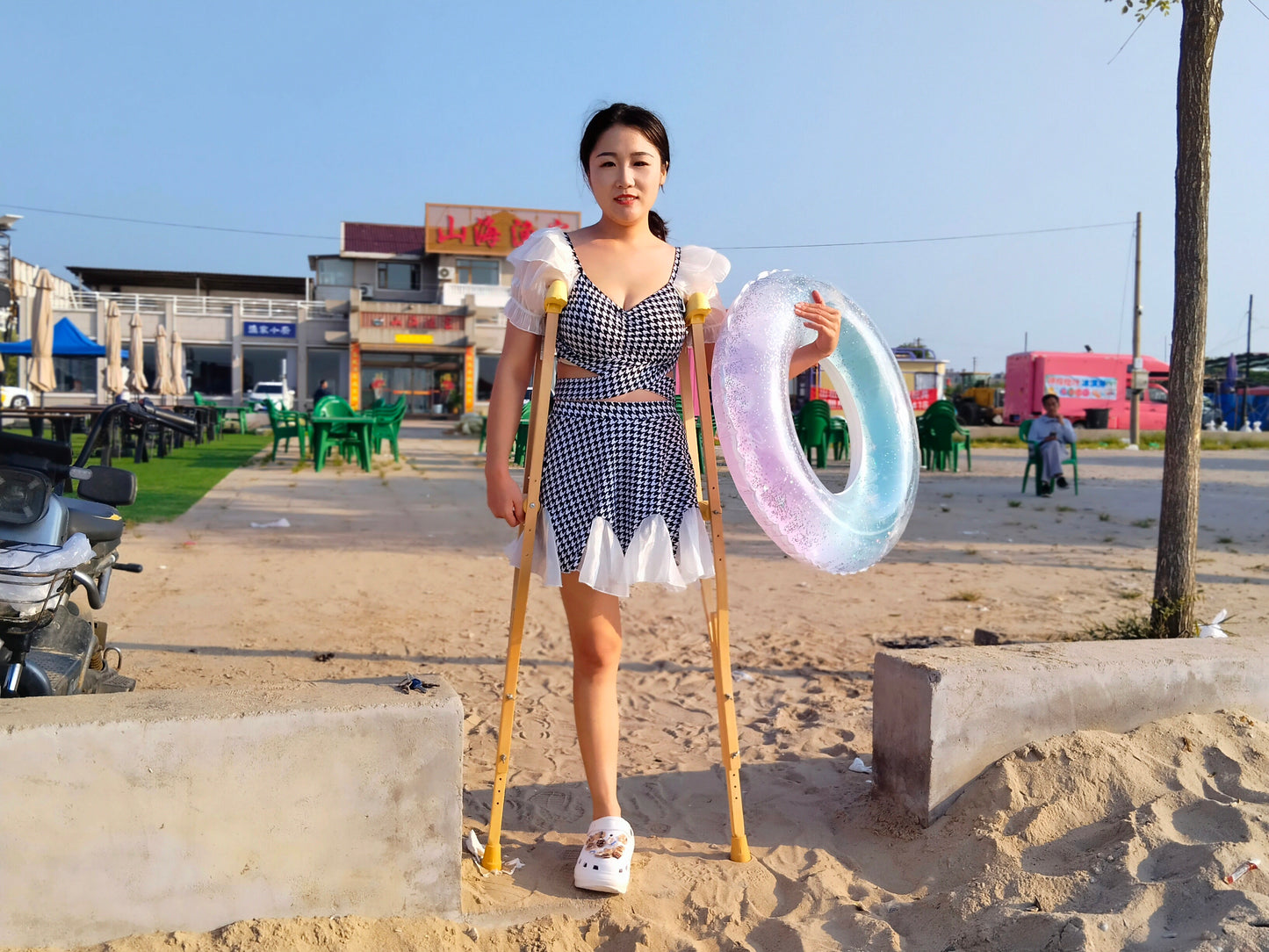 Naomi Sak, an amputee girl - swimming in the sea at the beach