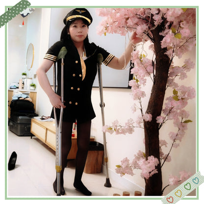 Twlia, a girl with polio, walks with crutches while wearing black stockings.