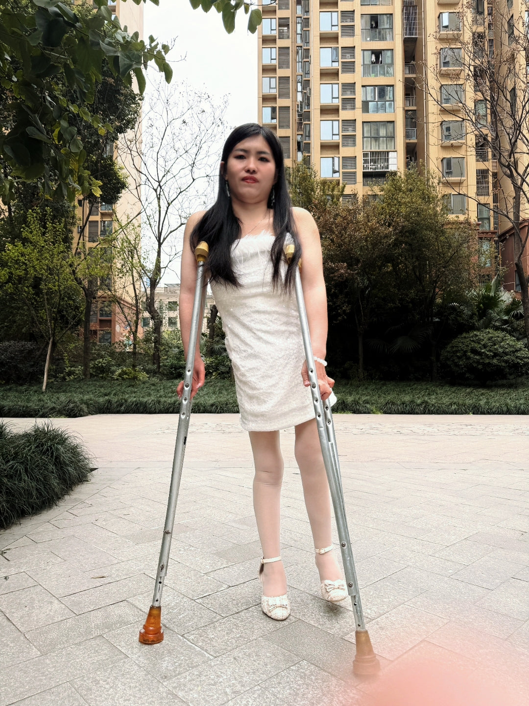 Maria: Polio Girl - Walking with crutches in a white chiffon dress