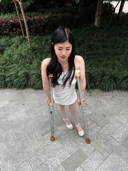 Maria: Polio Girl - Walking with crutches in a white chiffon dress