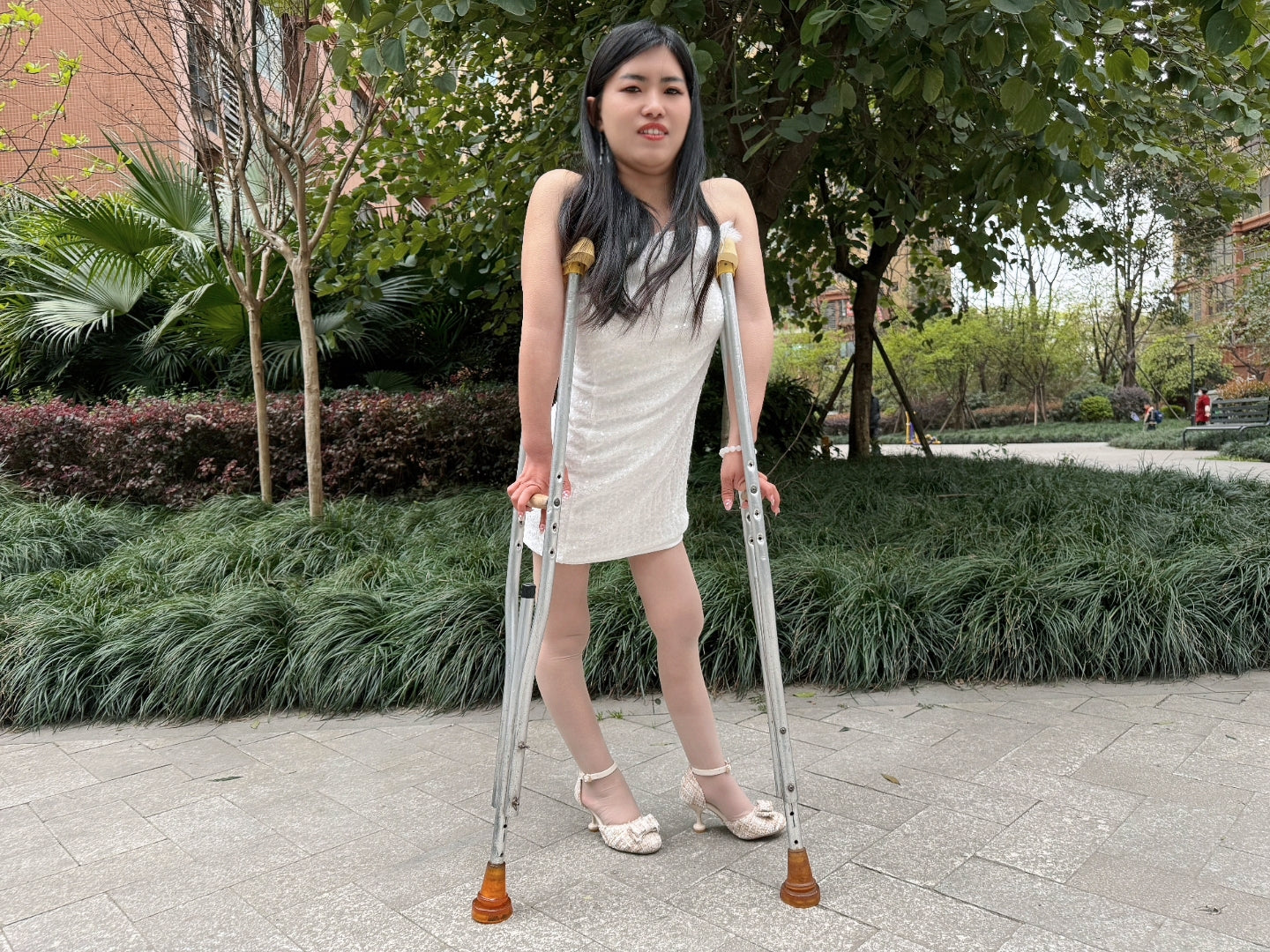 Maria: Polio Girl - Walking with crutches in a white chiffon dress