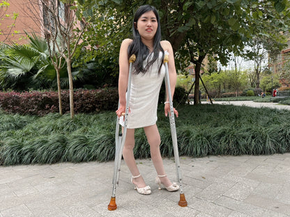 Maria: Polio Girl - Walking with crutches in a white chiffon dress